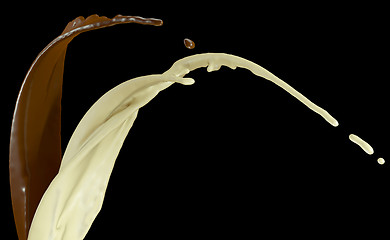 Image showing Hot dark and milk chocolate flows isolated on black
