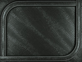 Image showing Black mock croc or alligator skin background with stitched patte