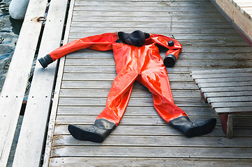 Image showing The diving suit lays on a pier