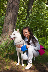 Image showing The young woman with a white dog on the nature