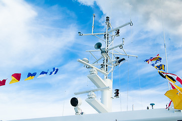 Image showing Mast with the navigating equipment of a yacht and alarm flags