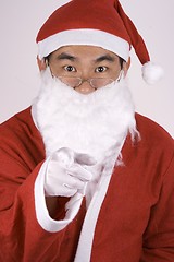 Image showing Asian Santa Claus Pointing