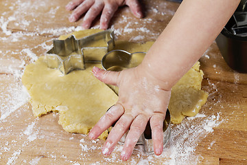 Image showing small childrens hands with dough