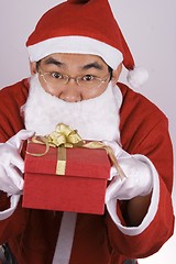 Image showing Asian Santa Claus With Present