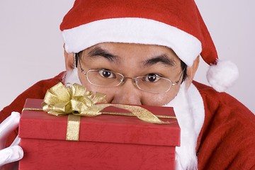 Image showing Asian Santa Claus With Present