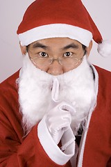 Image showing Asian Santa Claus Whispering