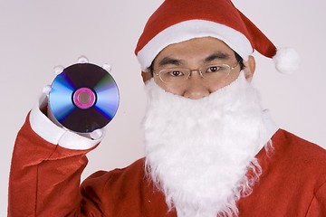 Image showing Asian Santa Claus Holding CD