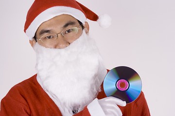 Image showing Asian Santa Claus Holding CD