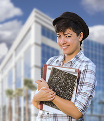 Image showing Mixed Race Female Student Holding Books in Front of Building