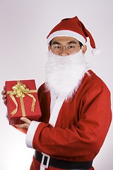 Image showing Santa Claus Holding A Present