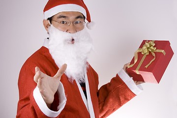 Image showing Santa Claus Holding A Present