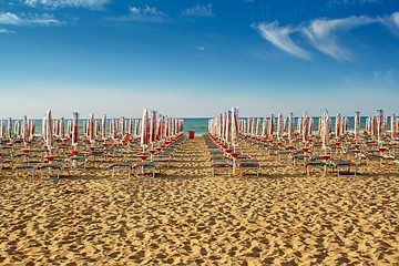 Image showing withdrawn umbrellas and sunlongers on the sandy beach