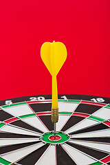 Image showing Dart sticks to bullseye on a dart board