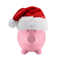 Image showing Piggy bank with christmas hat isolated