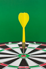 Image showing Dart sticks to bullseye on a dart board
