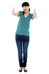 Image showing Amused woman gesturing double thumbs up
