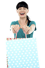 Image showing Cheerful woman holding polka dot shopping bags