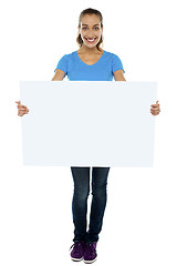 Image showing Trendy woman displaying blank billboard