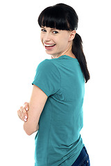 Image showing Gorgeous charming female turning and looking at camera