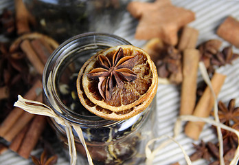 Image showing Cinnamon sticks and dry orange