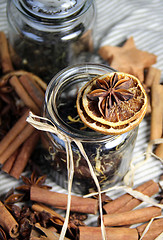 Image showing Cinnamon sticks and dry orange