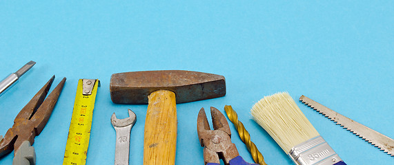 Image showing various construction work tools on blue 