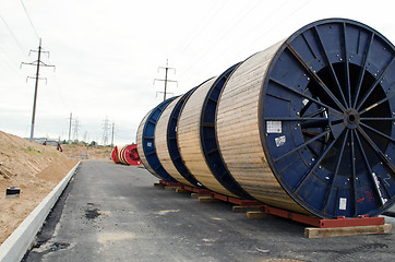 Image showing high voltage cable reels and road construction 