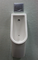 Image showing urinal with white painted a fly on the toilet