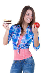 Image showing The girl picks an apple or a cake