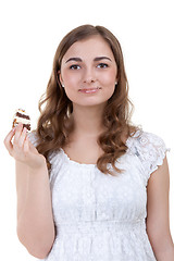 Image showing young woman eating the cake