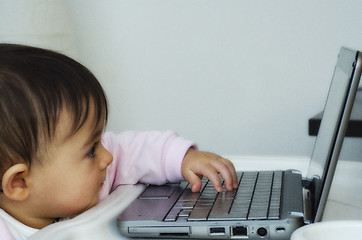 Image showing 1 Year Baby Girl trying to use her Netbook