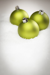 Image showing Green Christmas Ornaments on Snow Flakes with Text Room