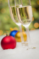 Image showing Christmas Ornaments and Champagne Glasses on Snow