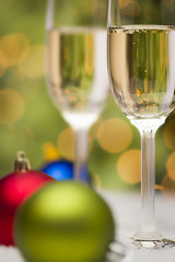 Image showing Christmas Ornaments and Champagne Glasses on Snow