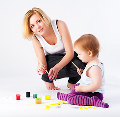 Image showing Pretty young mother and daughter drawing