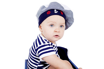 Image showing cute little baby in sailor fashion playing 