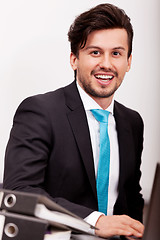 Image showing young businessman smiling at office