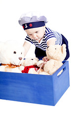 Image showing cute little baby in sailor fashion playing 