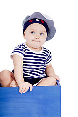 Image showing cute little baby in sailor fashion playing 