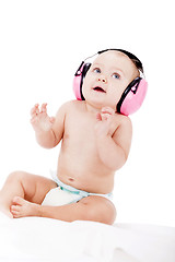 Image showing cute little baby with protection earphones 