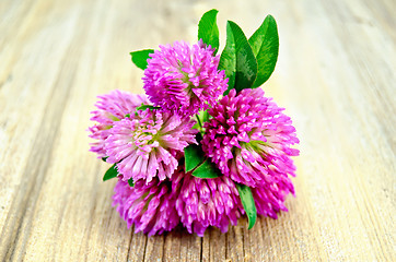 Image showing Clover bouquet on the old board