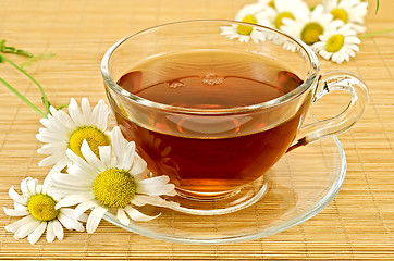 Image showing Herbal tea with camomiles on a bamboo