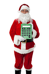 Image showing Old man dressed as Santa showing a large green calculator