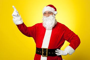 Image showing Cheerful Santa pointing away. Copy space concept.