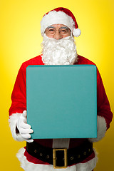 Image showing Isolated smiling Santa holding gift box