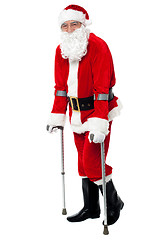 Image showing Santa walking with the help of crutches