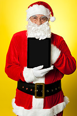 Image showing Kris Kringle presenting new updated tablet pc