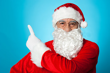 Image showing Father Christmas pointing away, copy space area
