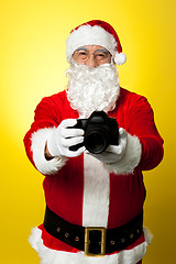 Image showing Santa Claus holding up his brand new DSLR