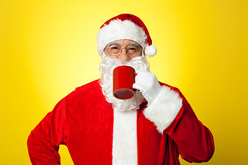Image showing Relaxed Santa enjoying his cup of coffee